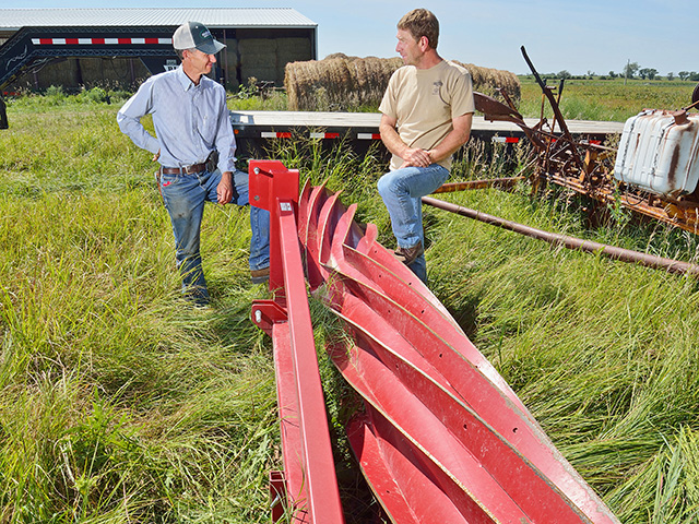 Kevin Karr (left) and Gail Fuller are trying their second cover-crop roller. This one has a roller pattern aimed at ensuring it crimps as many plants as possible. (Progressive Farmer image by Jim Patrico)